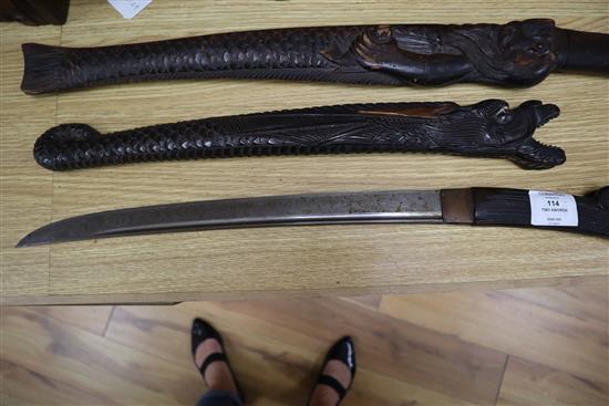Two 19th century Japanese swords the wood scabbards, carved as a dragon and a merman longest 67cm